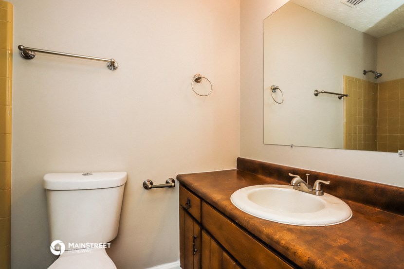 a bathroom with a sink and a toilet and a mirror