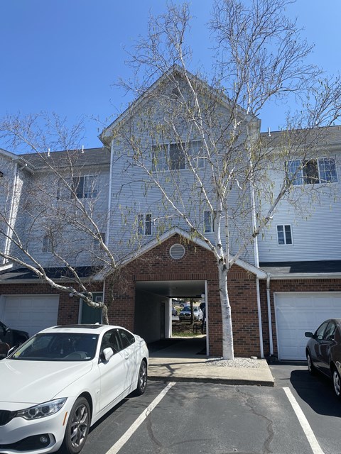 a white car parked in front of a house