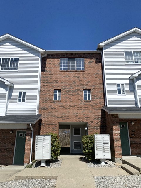 a brick building with a driveway in front of it