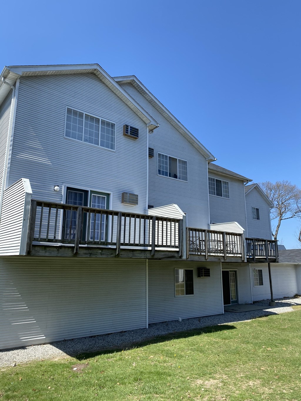 a white house with a balcony and a blue sky