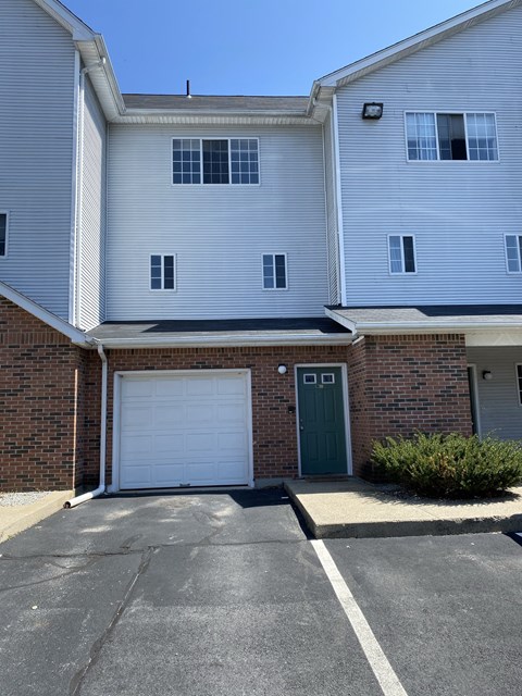 a white building with a garage door in front of it