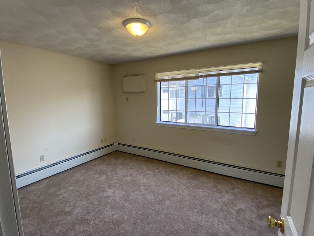 the living room of an empty house with a window