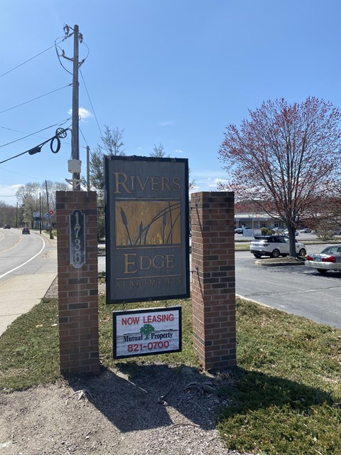 a sign for rivers edge on the side of a street