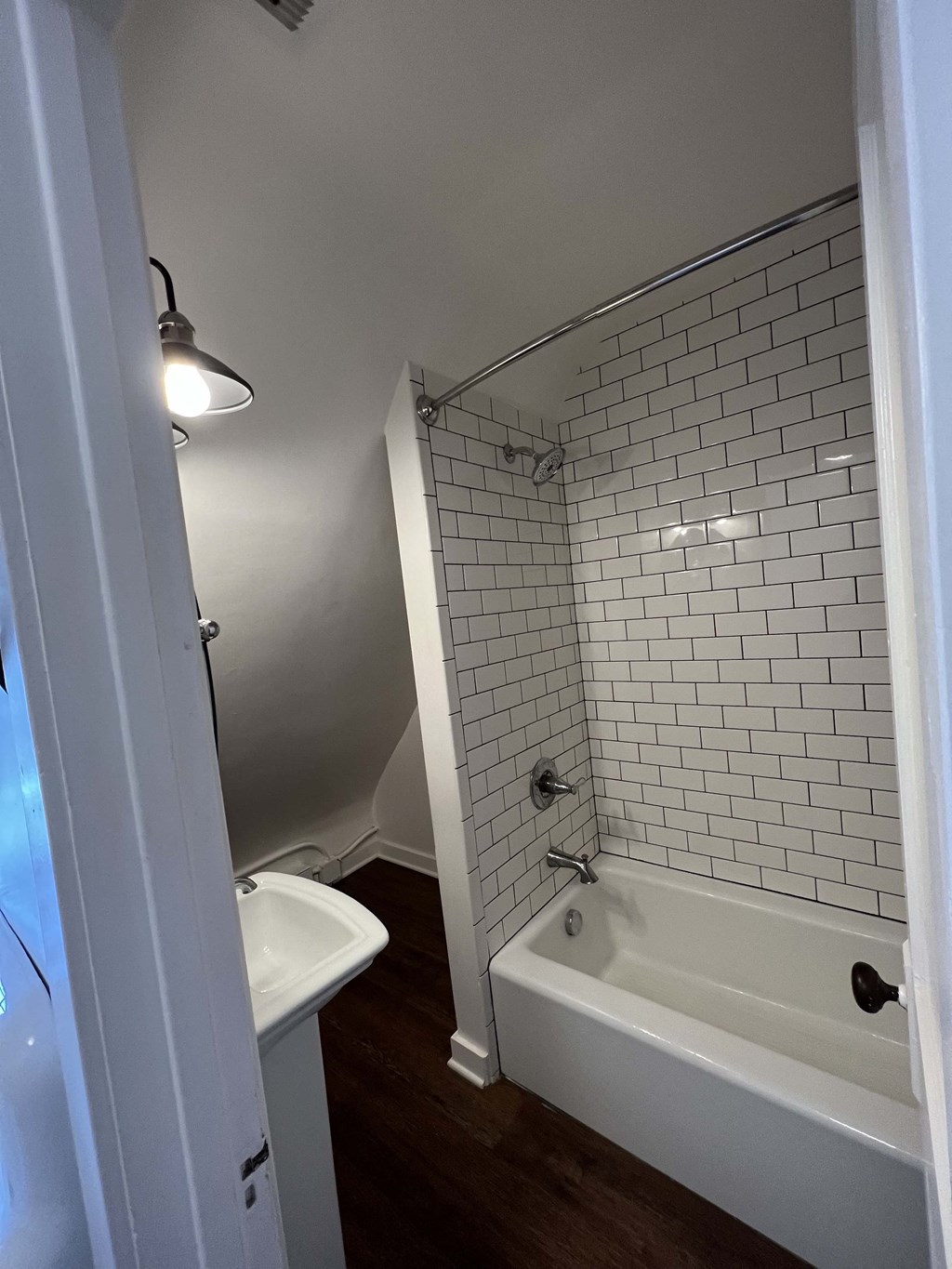 a small bathroom with a tub and a sink