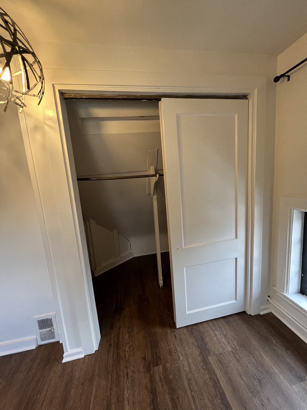 an empty closet in a home with a door open