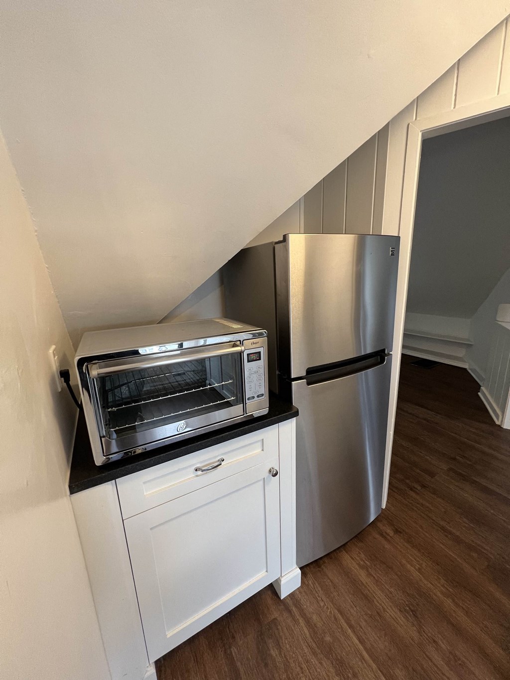a small kitchen with a refrigerator and a microwave