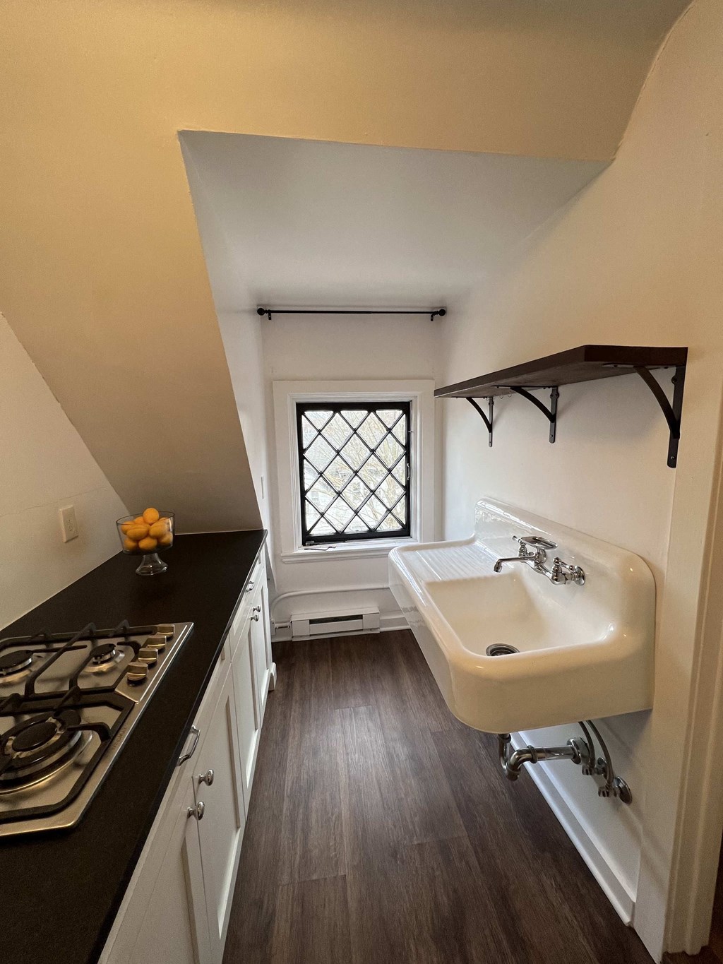 a kitchen with a sink and a window in a tiny house