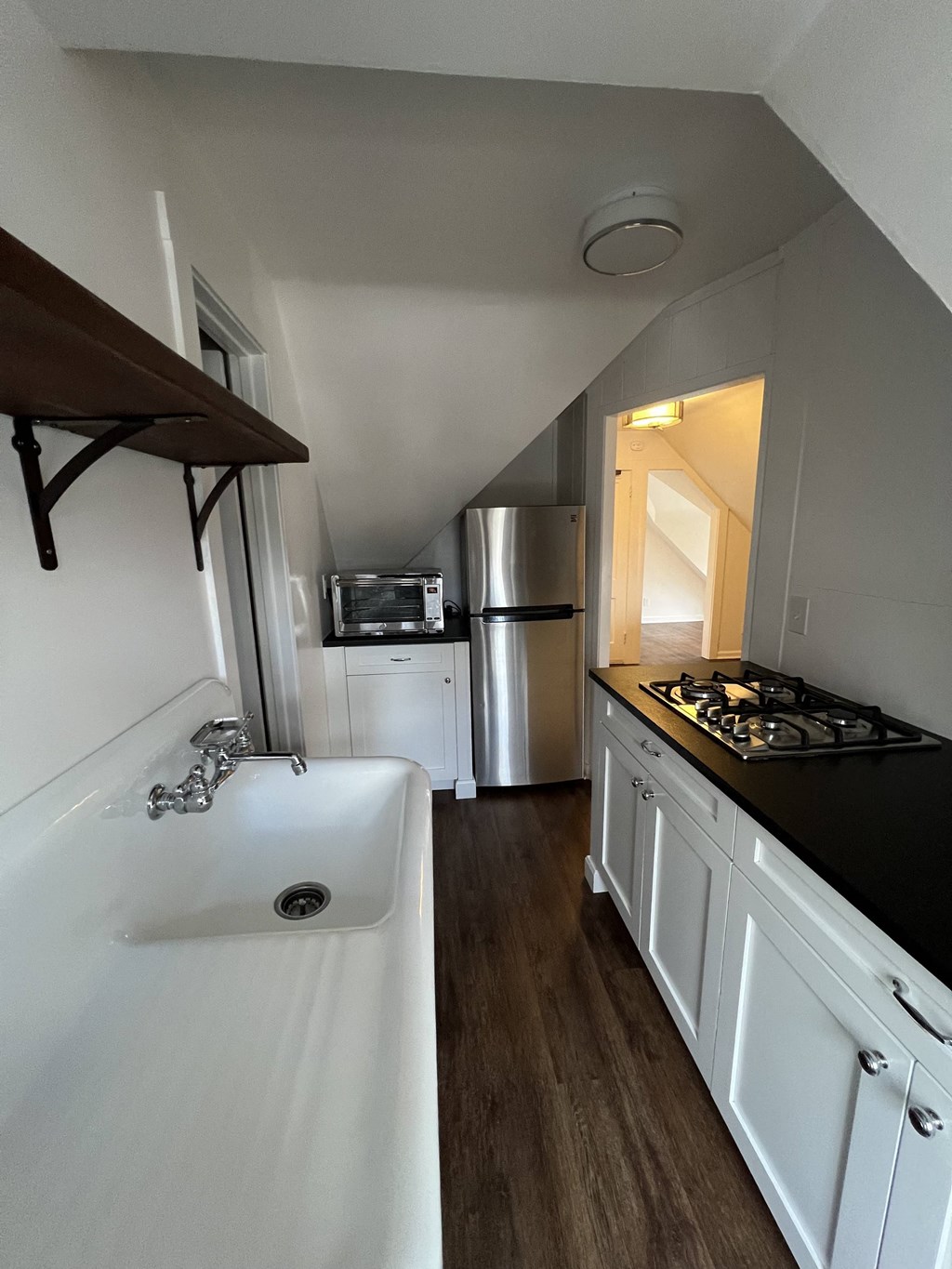 a kitchen with white cabinets and a sink and a refrigerator