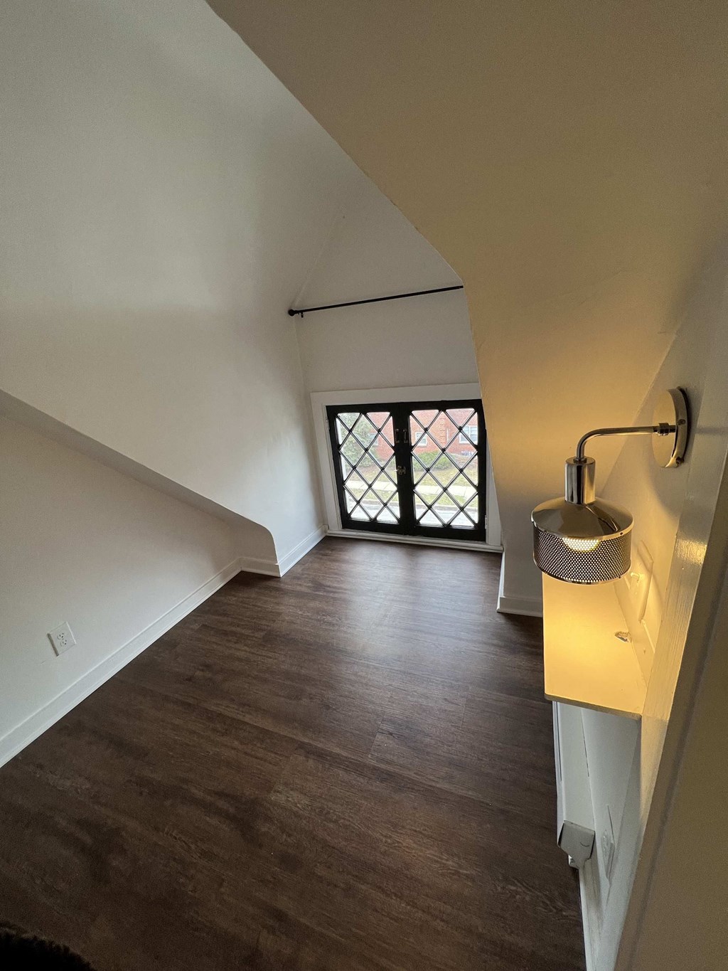 a loft space with a sink and a window