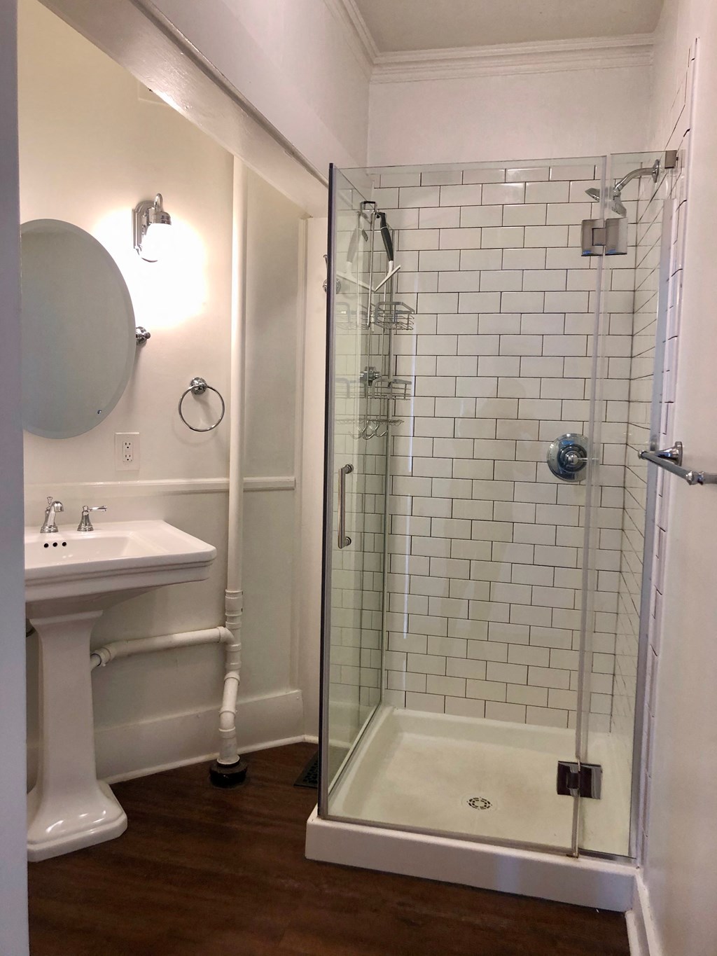 a small bathroom with a shower and a sink