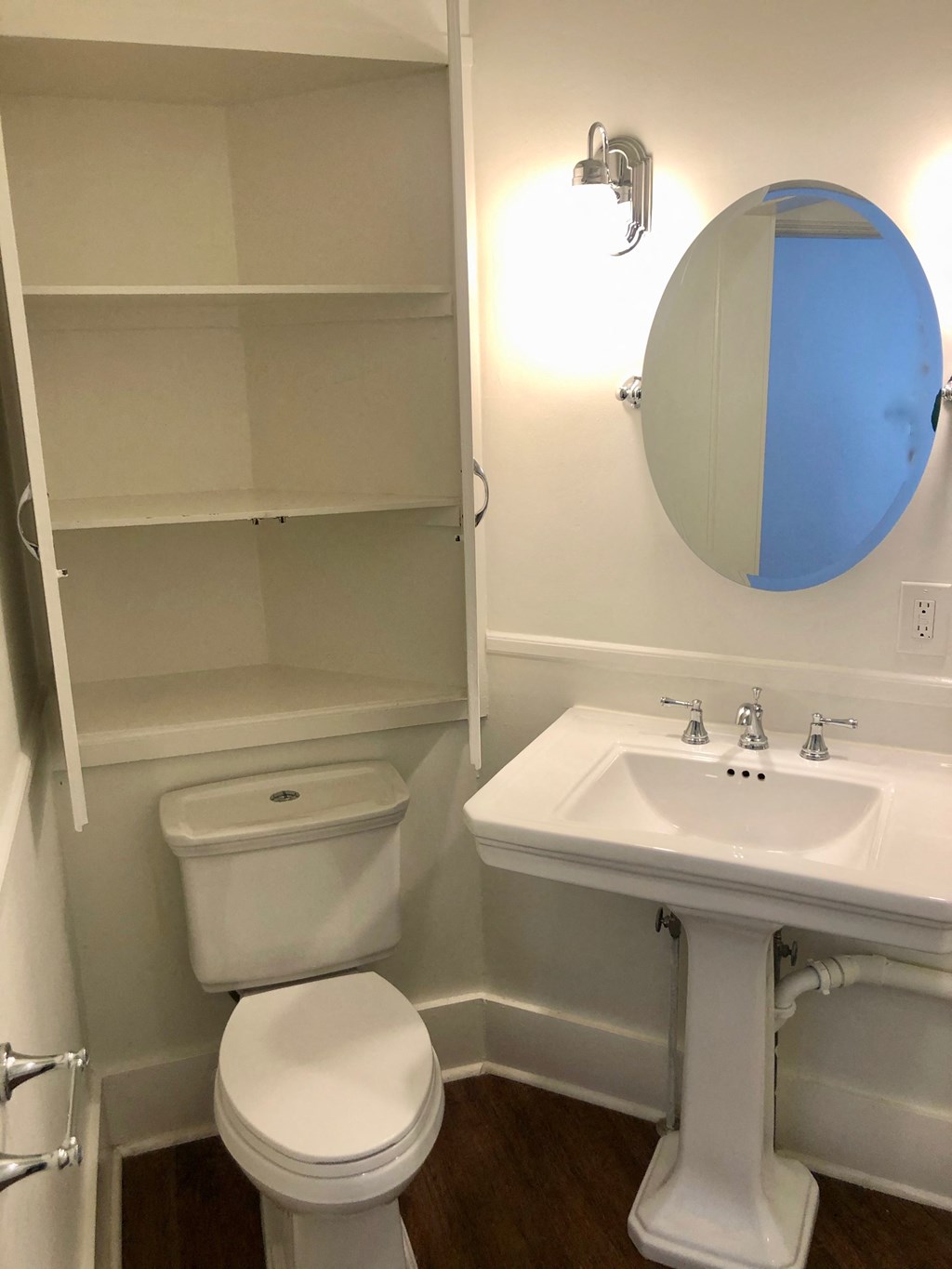 a bathroom with a toilet and a sink and a mirror