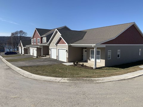 a row of houses with a street in front of them