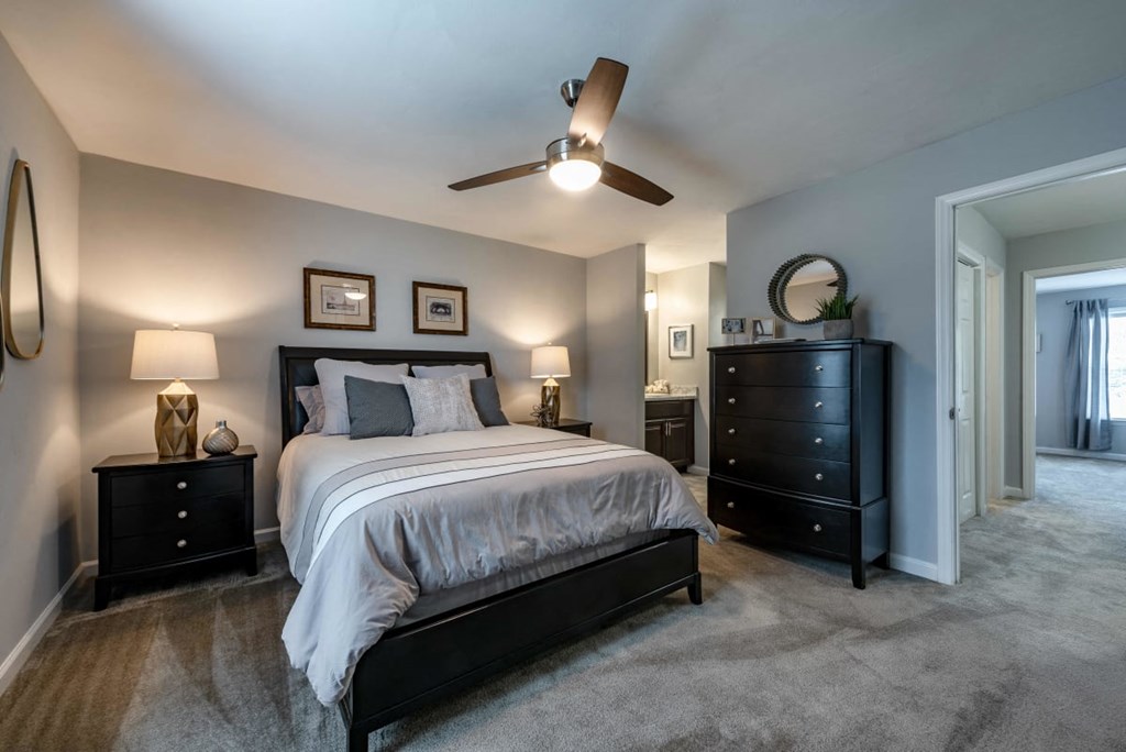 Bedroom with queen bed, dresser and night stands