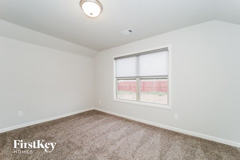 the living room of a home with carpet and a window