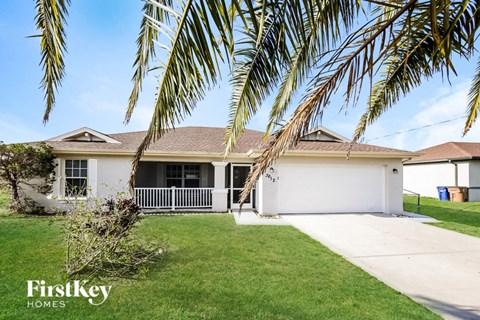a house with palm trees in front of it