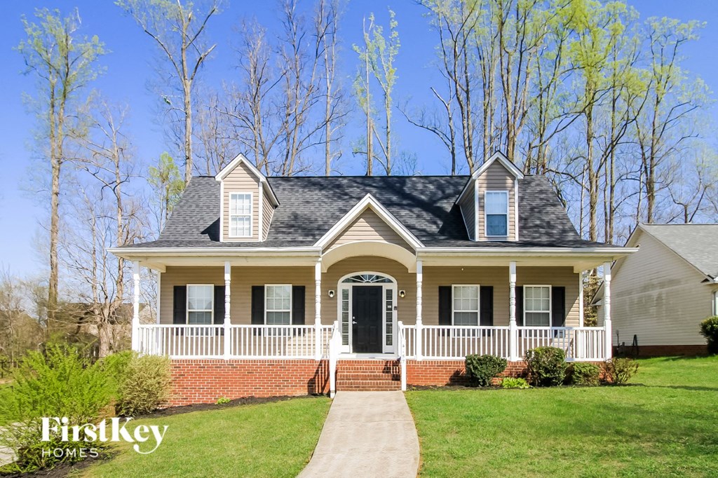a house with a white front porch and a black door