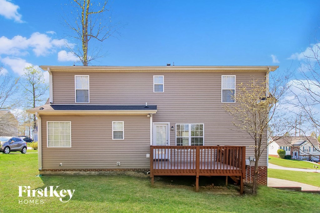 a home with a wooden deck in front of it