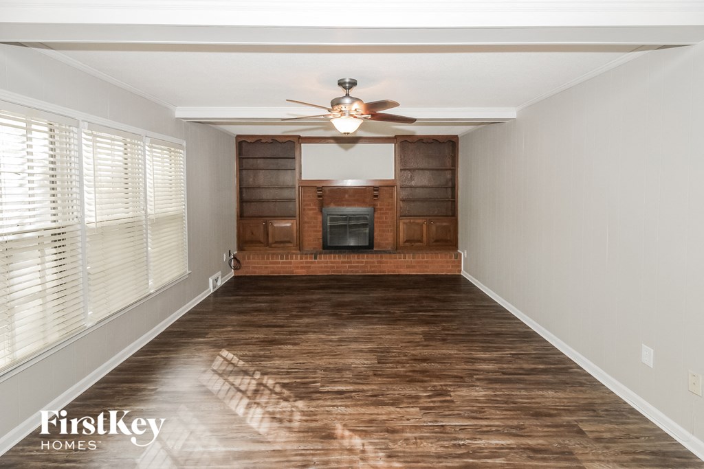 a living room with a wood floor and a ceiling fan