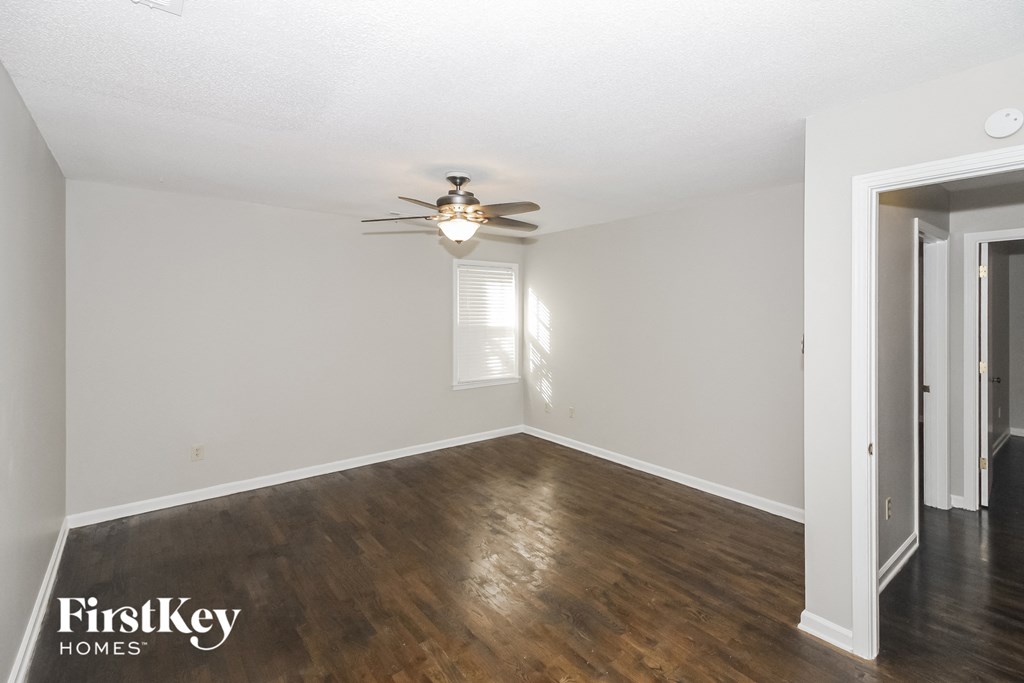 a living room with hardwood floors and a ceiling fan