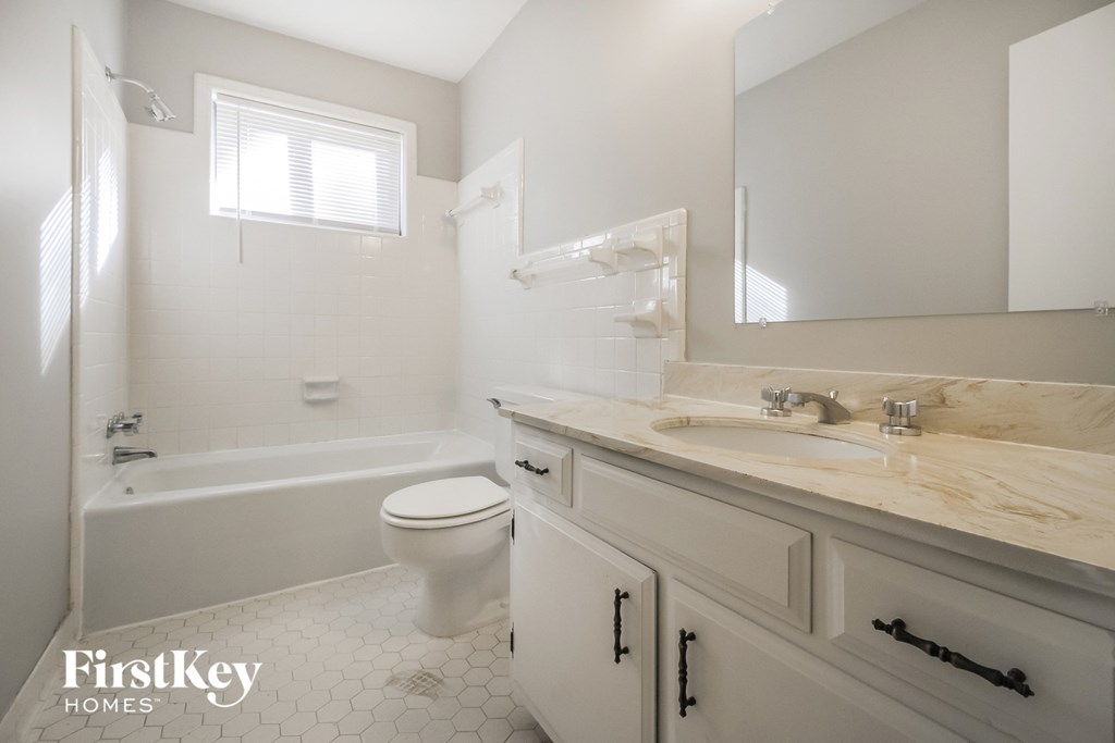 a white bathroom with a sink toilet and bath tub
