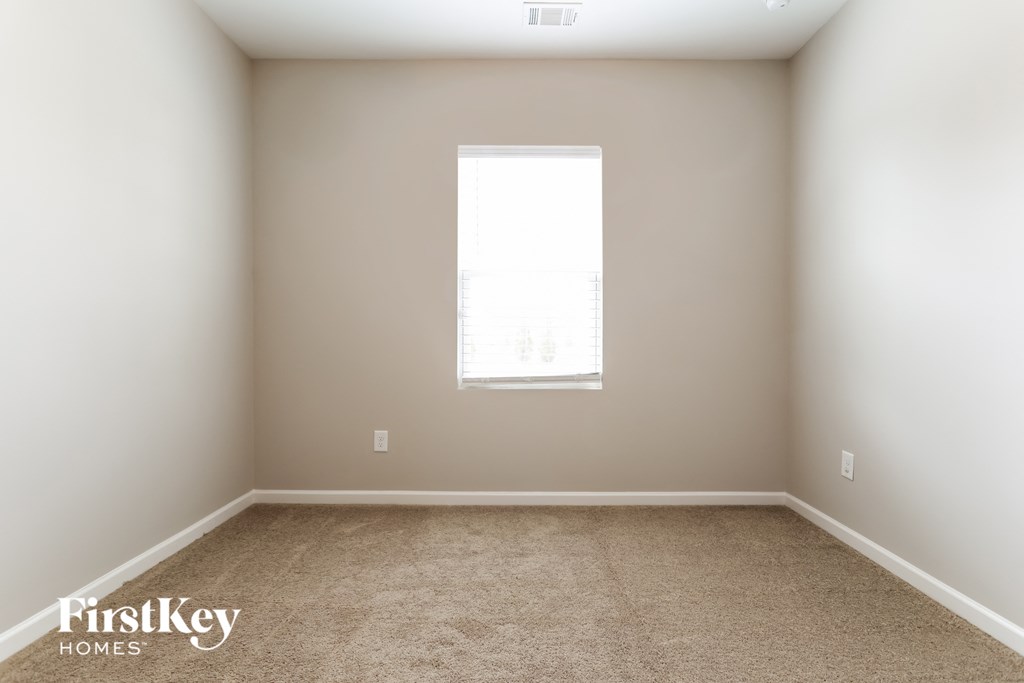a room with carpet and a window in it