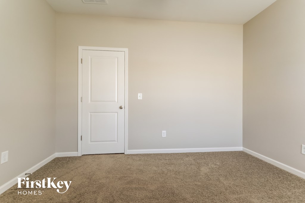 a room with carpet and a white door