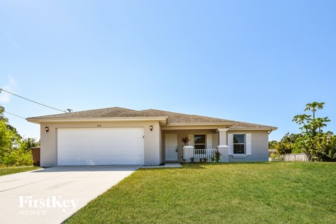 A house with a garage is for sale.
