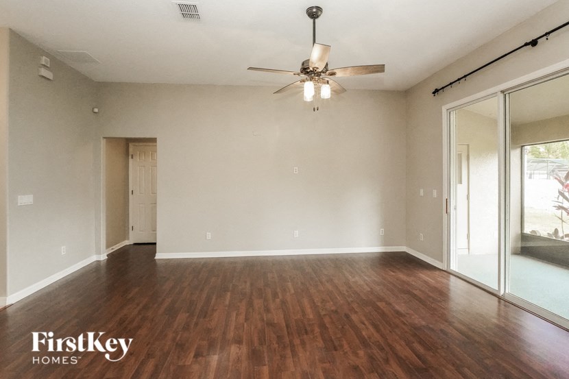 A room with wooden floors and a ceiling fan.
