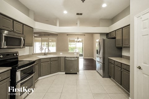 A kitchen with a FirstKey Homes logo.