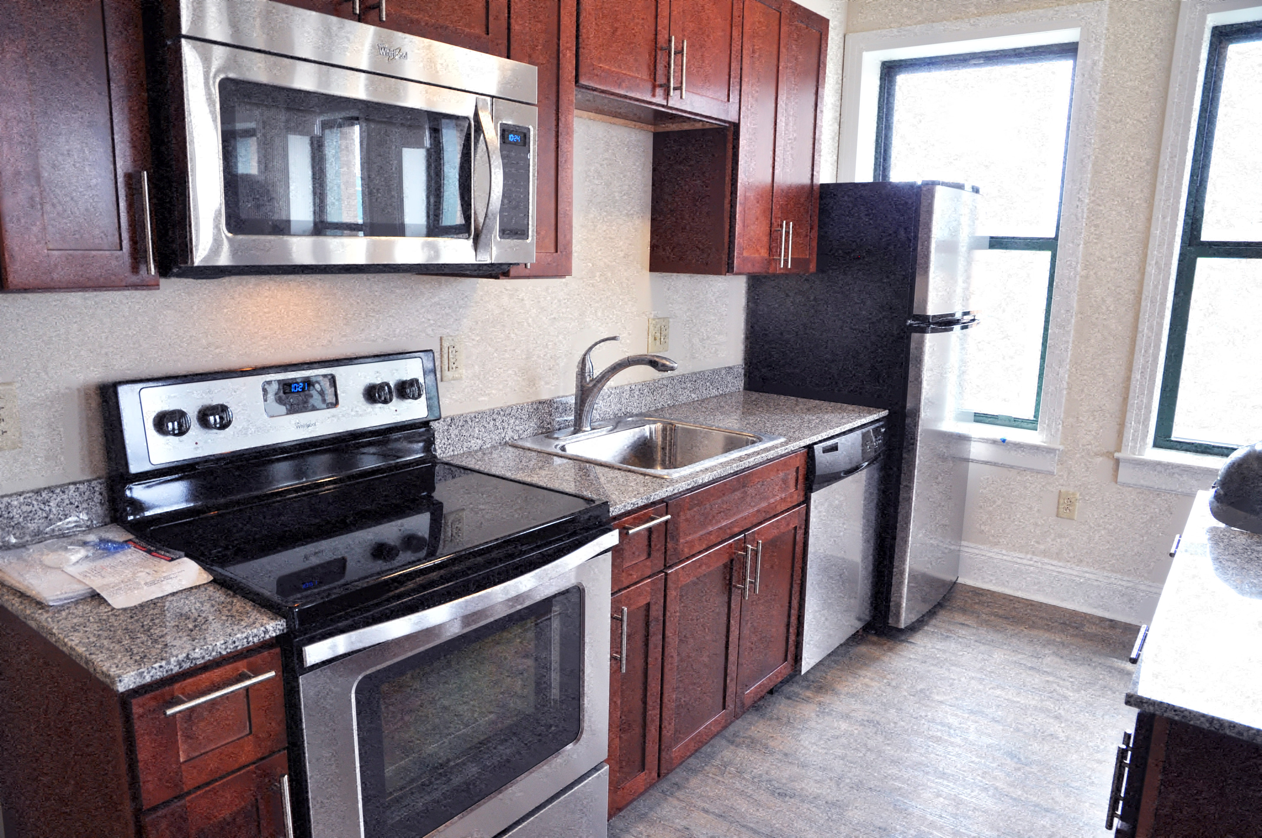 a kitchen with a stove and a sink and a microwave