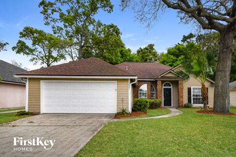 a home with a white garage door and a lawn