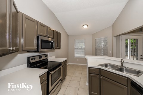 a kitchen with stainless steel appliances and white counters