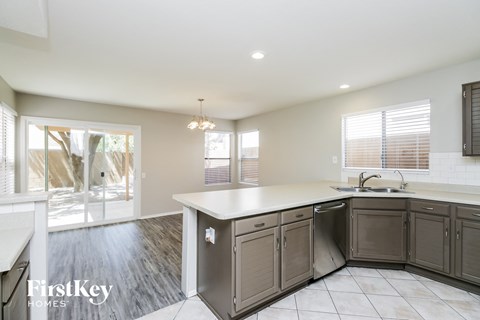a kitchen with a white counter top and a sink