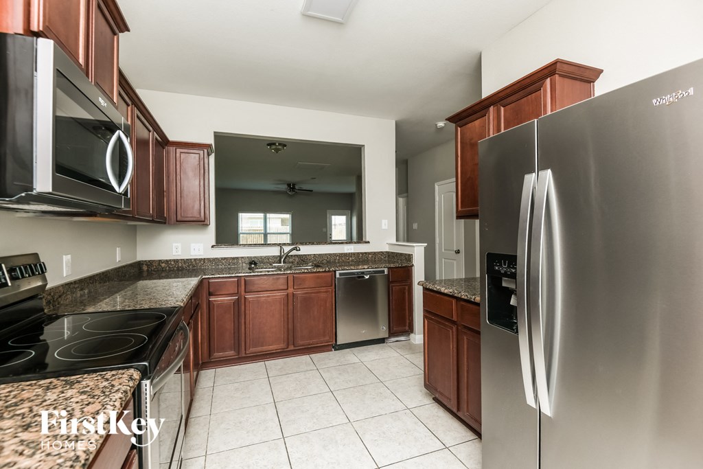 a kitchen with stainless steel appliances and granite counter tops