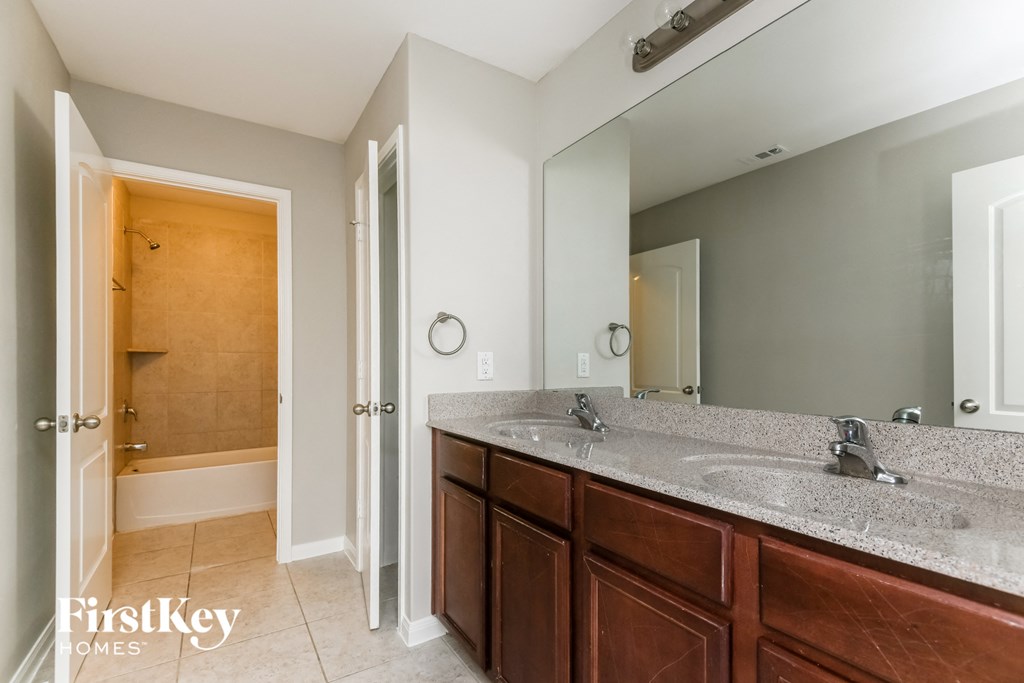 a bathroom with two sinks and a large mirror