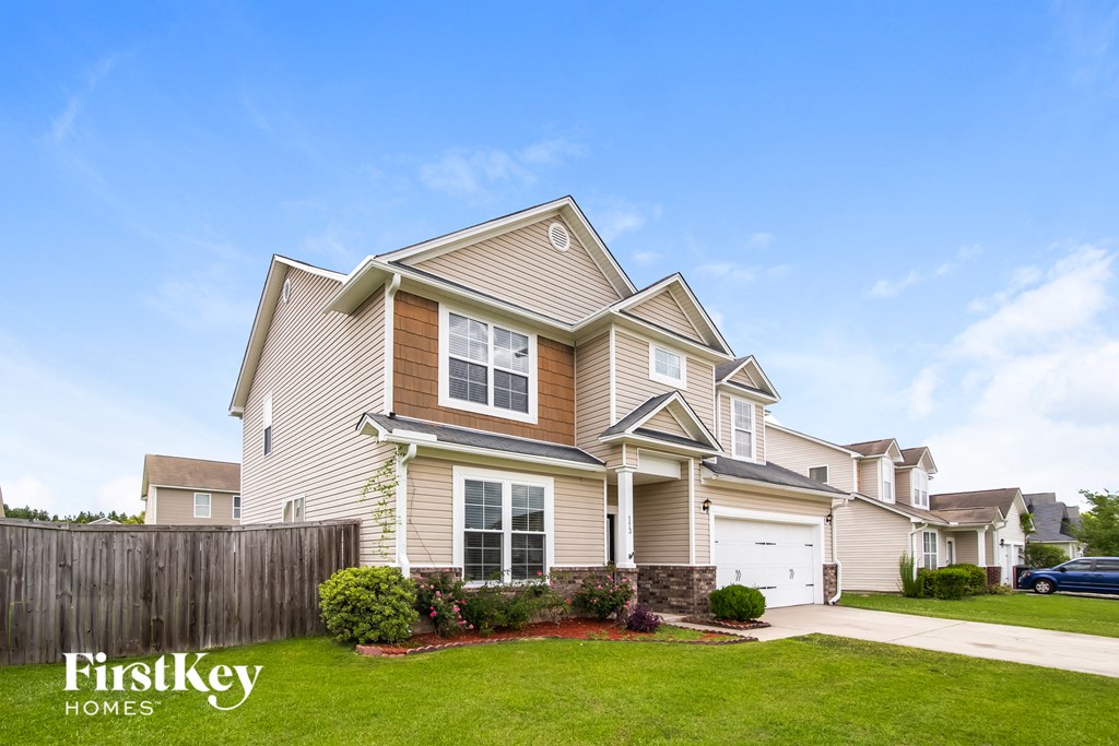 A large house with a garage is shown in the image.