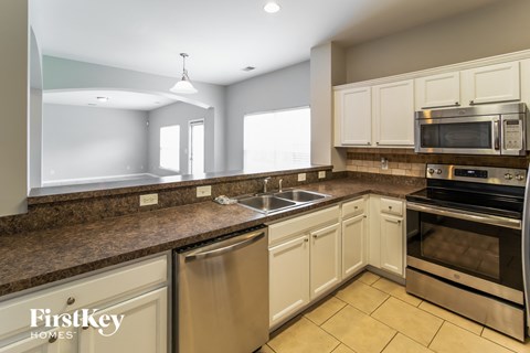 A kitchen with a stainless steel dishwasher and oven.