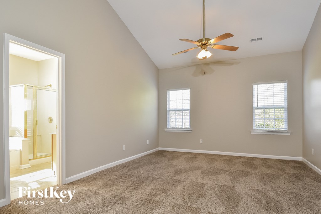 the master bedroom is spacious and has a ceiling fan