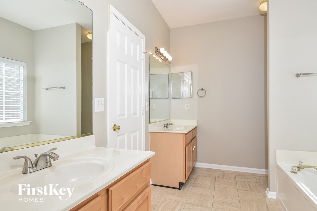 a bathroom with a sink and a mirror and a shower