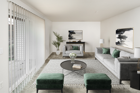 a living room with white walls and green furniture