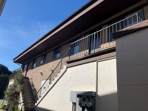 A building with a staircase and a balcony.