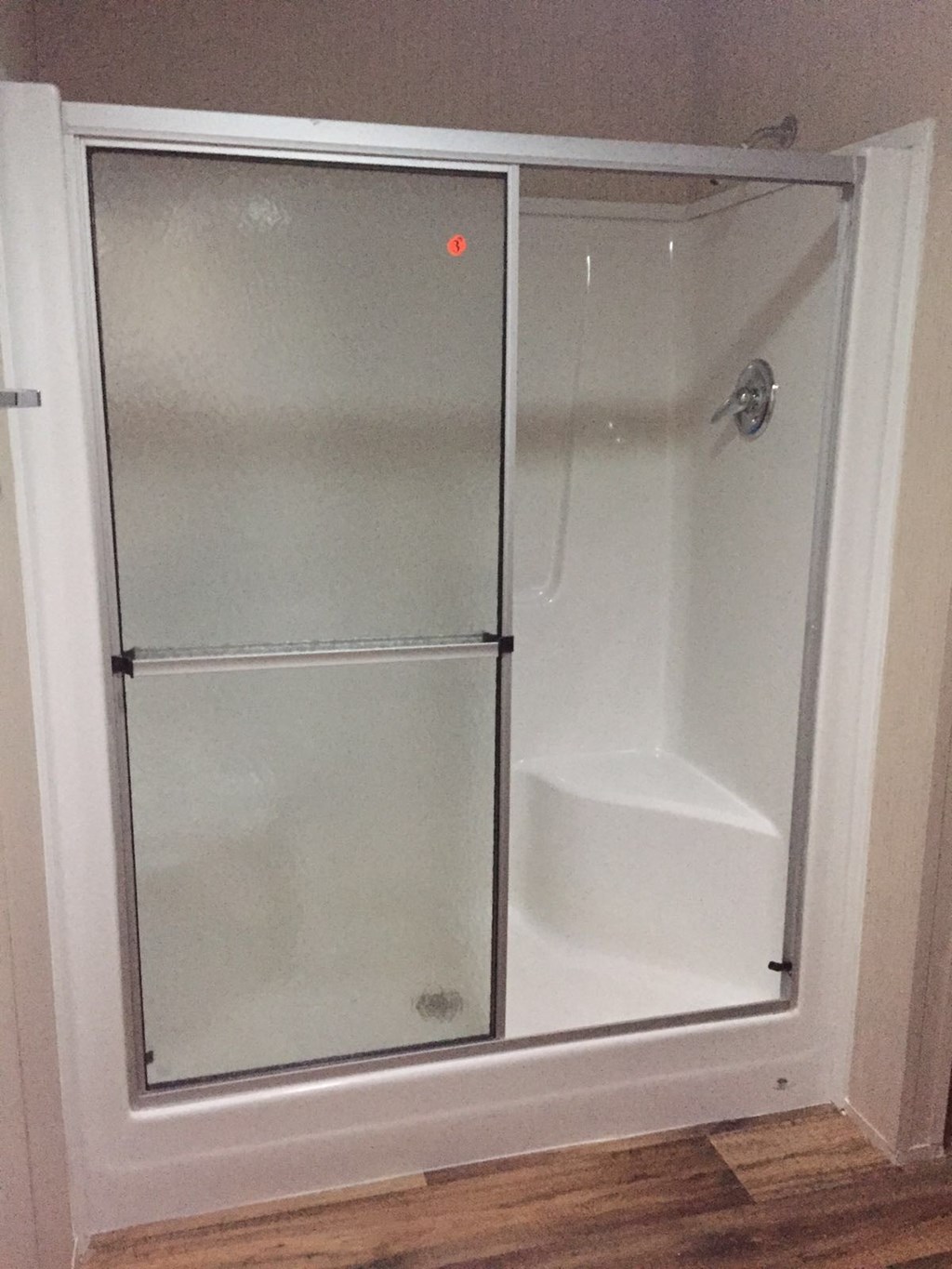 a bathroom with a shower with a glass door