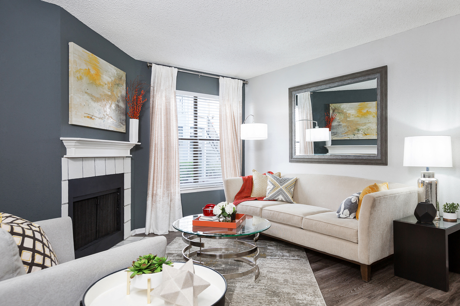a living room with a couch and a table and a fireplace