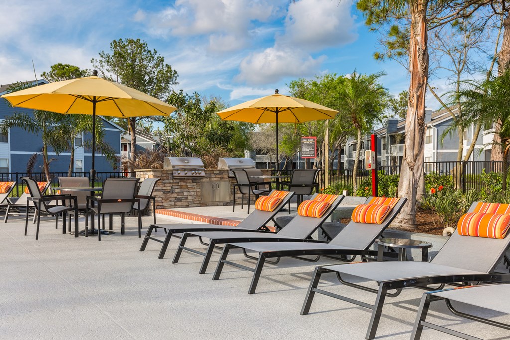 a patio with tables and chairs and umbrellas