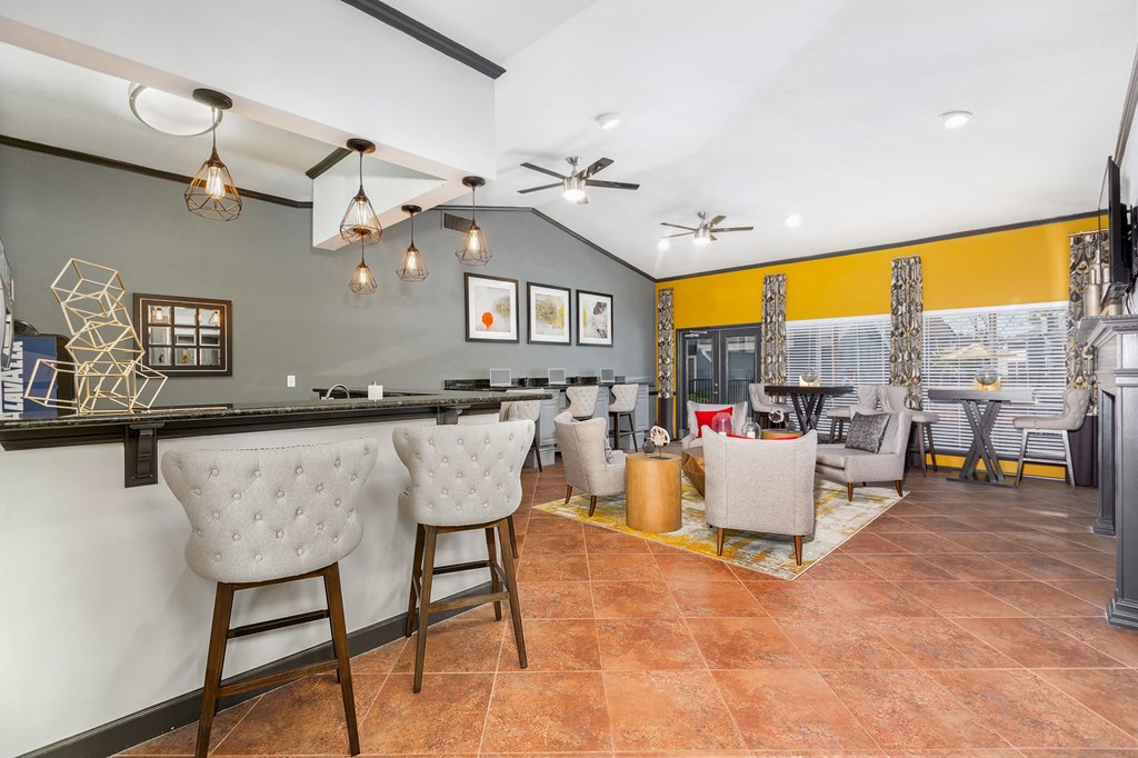 a living room with a bar and a dining room