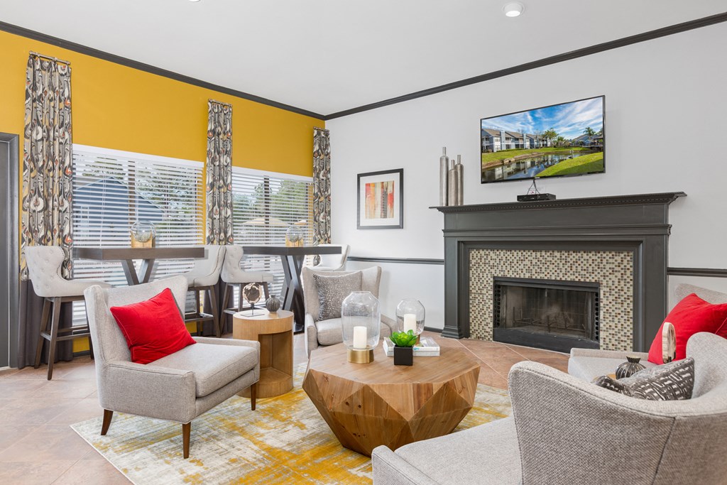 a living room with couches and chairs and a fireplace