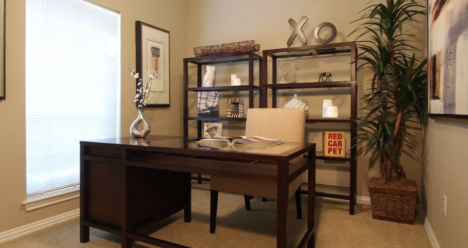 Luxury apartments with den or office space, built-in shelves, and wet bar at The Saxony Apartments in north Dallas