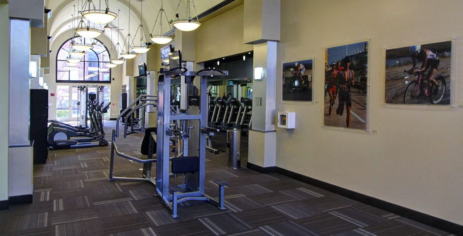 Luxury apartments with huge fitness center with multiple varieties of workout equipment, free weights, yoga and spin rooms at The Lanesborough Apartments in Houston