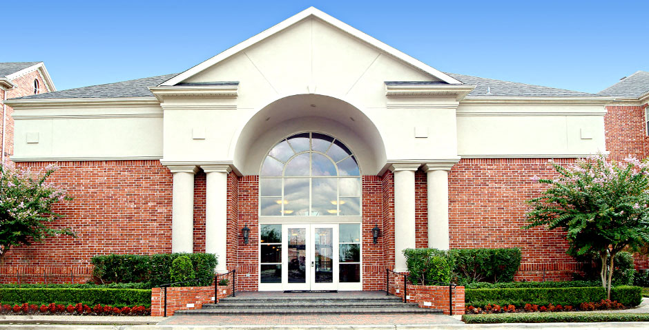 img src="clubhouse.png" alt="red brick exterior of building with glass door and arch"