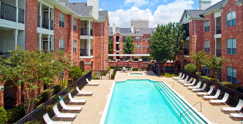 Luxury apartments with large swimming pool, multiple swimming pools, spa, and large sundeck with poolside lounge chairs at The Lanesborough Apartments in Houston